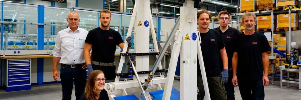 Das Projektteam von Bosch Rexroth steht neben dem automatisierten Basketballkorb. Das Projektteam von Bosch Rexroth steht neben dem automatisierten Basketballkorb.