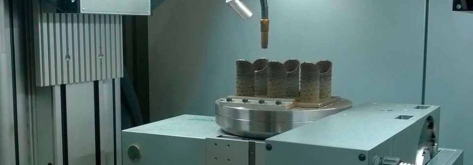 Gefertec hat auf der formnext 2017 eine neue kleinere, kompaktere Einsteigerversion seiner GTarc-Maschine vorgestellt. Sie ermöglicht die kostengünstige und schnelle Herstellung von endkonturnahen Rohlingen aus Metall. Gefertec hat auf der formnext 2017 eine neue kleinere, kompaktere Einsteigerversion seiner GTarc-Maschine vorgestellt. Sie ermöglicht die kostengünstige und schnelle Herstellung von endkonturnahen Rohlingen aus Metall.