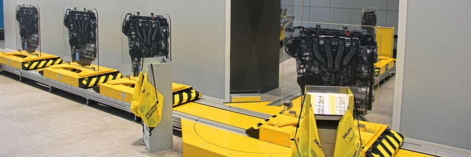 Beim Logomat-E-Cart- V2-System fährt ein elektrisches E-Cart mannlos auf einer Laufschiene. Drehmodule können die Laufrichtung ändern. Beim Logomat-E-Cart- V2-System fährt ein elektrisches E-Cart mannlos auf einer Laufschiene. Drehmodule können die Laufrichtung ändern.