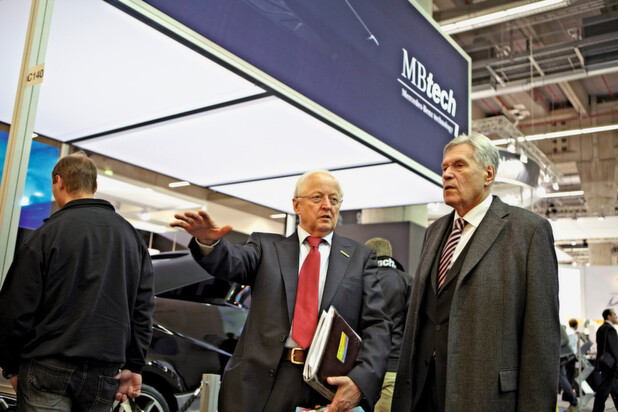 Demat Managing Director Eberhard Döring guides former German Economics and Technology Minister Michael Glos around the show floor at EuroMold 2011.